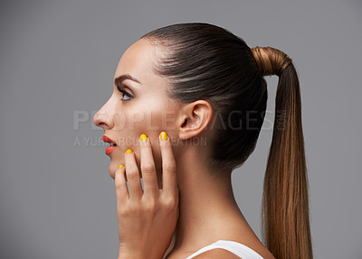 Buy stock photo Manicure, face and profile of woman in makeup, beauty and cosmetics with nails and hair care on grey background. Hand, yellow nail polish and lipstick with skin, glamour and shiny ponytail in studio