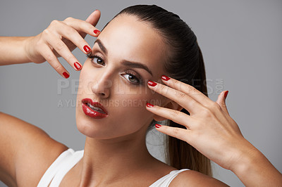 Buy stock photo Woman, face and hands with beauty and manicure, nail polish and cosmetic care for skin on grey background. Portrait, confidence and bold makeup with red lipstick and color nails for glamour in studio