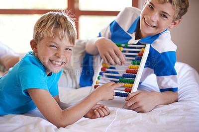 Buy stock photo Children, home and portrait with abacus for learning, happy and bonding together by education toy for math. Brother, smile on face and counting game on bed for sibling love,  and development in house