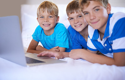 Buy stock photo Brothers, home and portrait on laptop in bedroom, above and excited for online games in house. Young children, happy face and streaming cartoons on bed for bonding together, love and relax on weekend