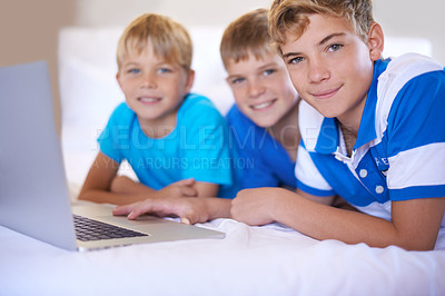 Buy stock photo Children, home and portrait on laptop in bedroom, smile and excited for online games in house. Young kids, happy face and streaming cartoons on bed for bonding together, siblings and relax on weekend