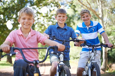 Buy stock photo Nature, smile and portrait of children on bicycle riding in outdoor field, park or forest for exercise. Happy, cycling and confident young boy kids on a bike for cardio, hobby or training in a garden
