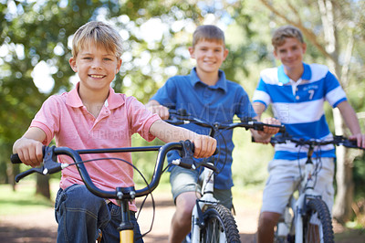 Buy stock photo Nature, smile and portrait of kids on bicycles riding in outdoor field, park or forest for exercise. Happy, cycling and confident young boy children on bikes for cardio, hobby or training in a garden