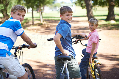 Buy stock photo Nature, happy and portrait of kids on bicycles riding in outdoor field, park or forest for exercise. Smile, cycling and confident young boy children on bikes for cardio, hobby or training in a garden