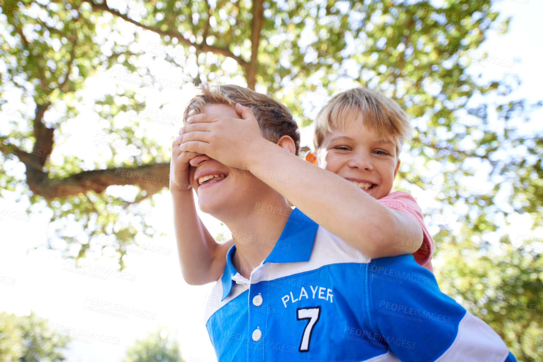 Buy stock photo Children, brother and piggyback in backyard playing or sunshine with cover eyes, game or laughing. Kids, siblings and together in nature for summer bonding activity for happiness, youth or friends