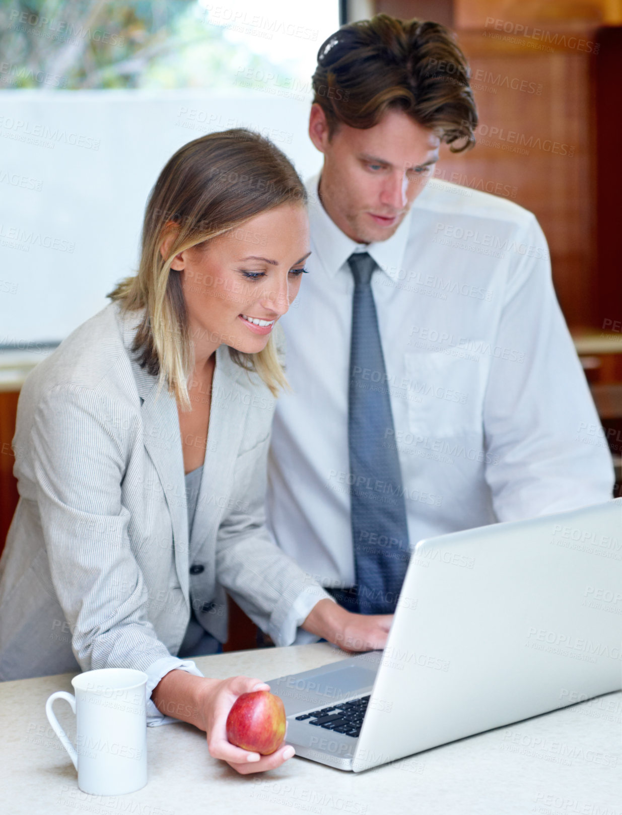 Buy stock photo Happy couple, coffee and apple by laptop in kitchen for morning, healthy breakfast or research at home. Man and woman with cup of tea and organic fruit in remote work, meal or nutrition on computer