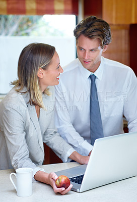 Buy stock photo Happy business couple, laptop and discussion with apple for breakfast, healthy meal or morning nutrition in kitchen at home. Man or woman talking in remote work with computer, coffee or organic fruit