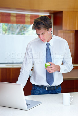 Buy stock photo Laptop, fruit and business man in kitchen for morning routine, remote working and healthy breakfast. Professional, worker and person on computer for website, research and internet in home with apple