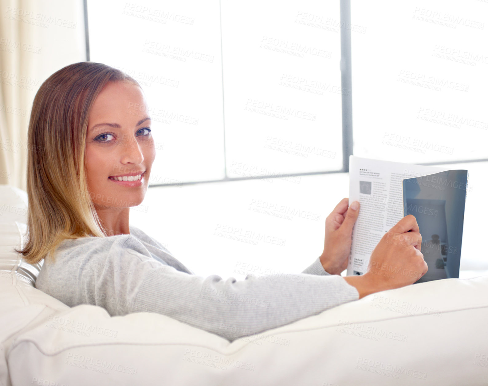 Buy stock photo Woman, magazine and portrait on sofa with relax for story, article or information and happy in living room. Person, face and morning routine on couch with print media or lifestyle blog for break