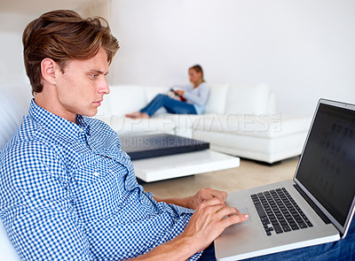 Buy stock photo Man, laptop and remote work in a living room with online career, typing and internet research for job. Home, computer and freelancer with graphic design and technology in a house with email in lounge