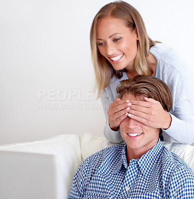 Buy stock photo A beautiful young woman covering her boyfriend's eyes to surprise him