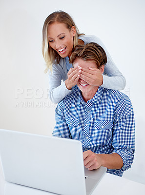 Buy stock photo Laptop, cover eyes and couple on sofa in home for internet, online website and social networking. Happy, surprise and man and woman on computer for relaxing, streaming subscription and remote work