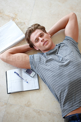 Buy stock photo Notebook, floor and portrait of man with hands on head for resting, studying and writing in home. Student, free time and above of person on ground with journal, cellphone and learning on weekend