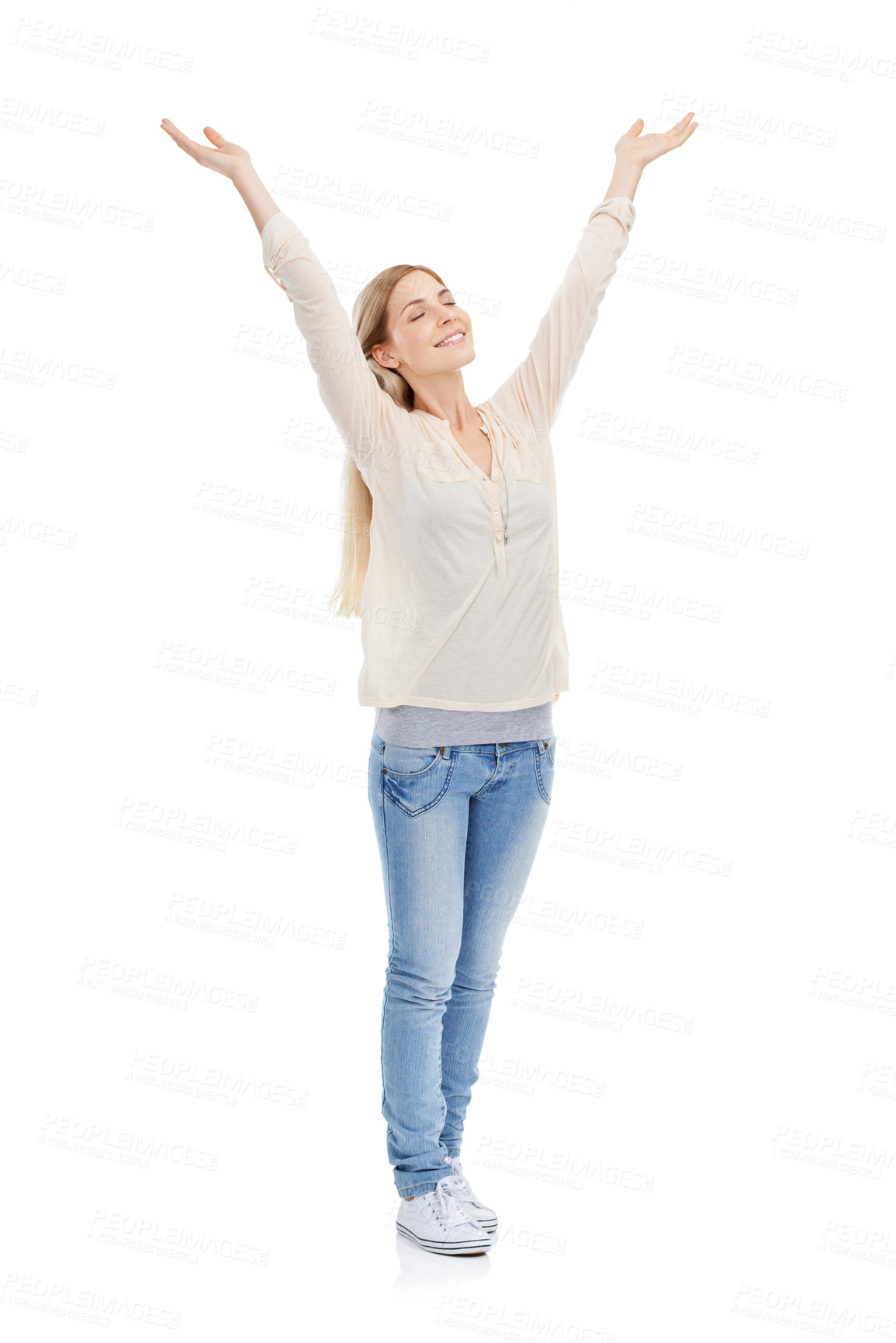 Buy stock photo Full length studio shot of a young woman with her eyes closed raising her arms over her head isolated on white