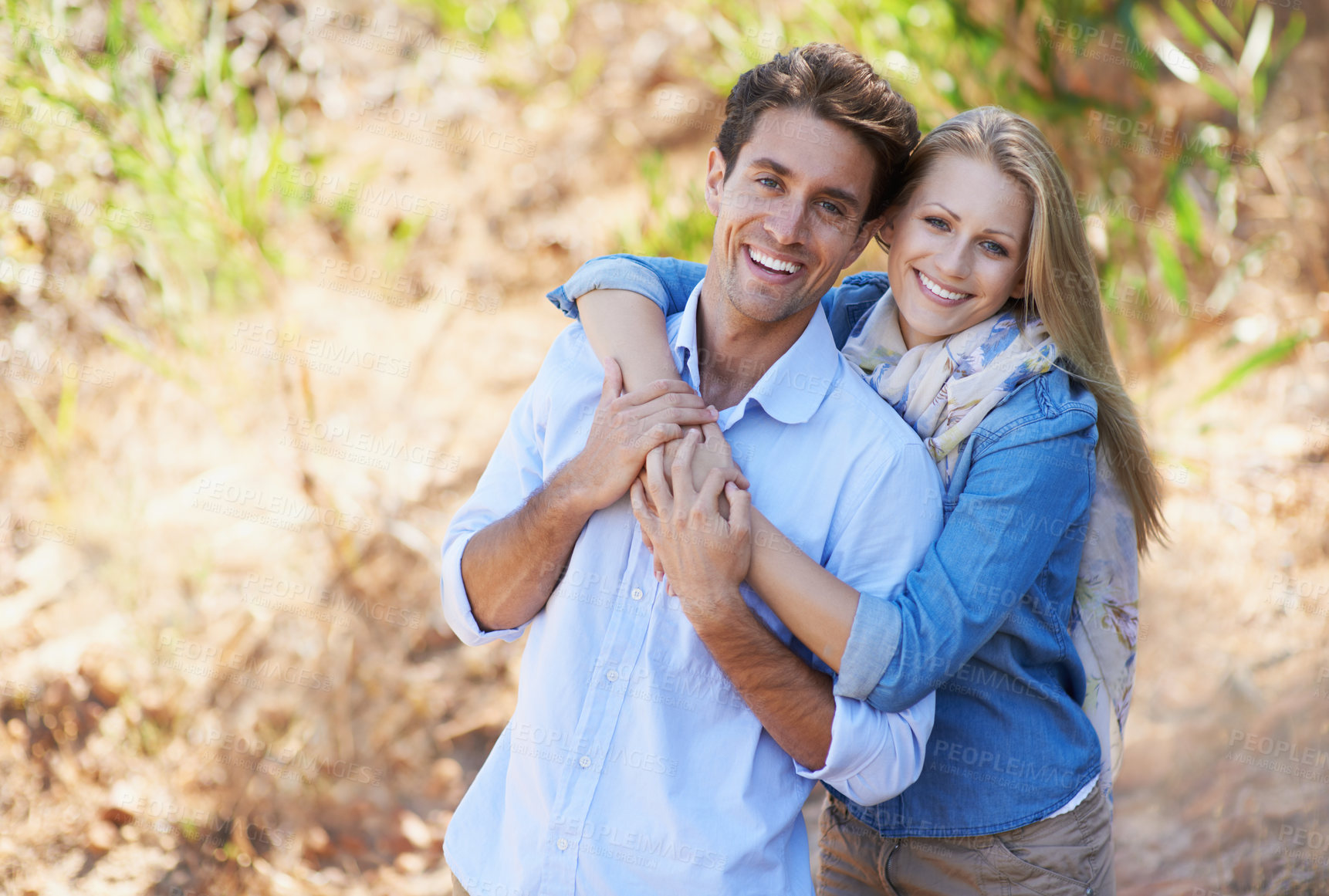 Buy stock photo A cropped view of a romantic young couple standing together outdoors
