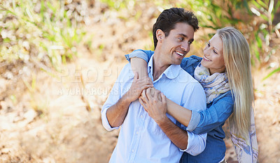 Buy stock photo Happy couple, hug and nature for love, support or affection in outdoor walk or bonding. Young woman and man smile in natural care or trust for embrace, comfort or romance in forest or woods together