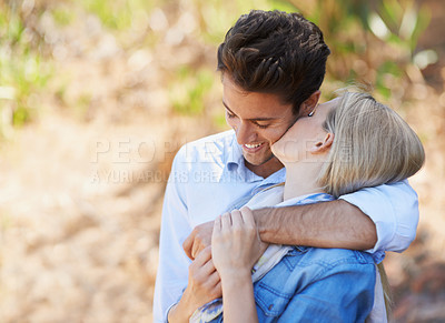 Buy stock photo Happy couple, kiss and hug in nature for bonding, love or support in relax for outdoor affection. Face of young woman and man with smile for embrace, comfort or romance in forest or woods together
