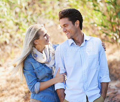 Buy stock photo Happy couple, walking and hug in nature for bonding, love or support in relax for outdoor affection. Face of young woman and man with smile for embrace, comfort or romance in forest or woods together