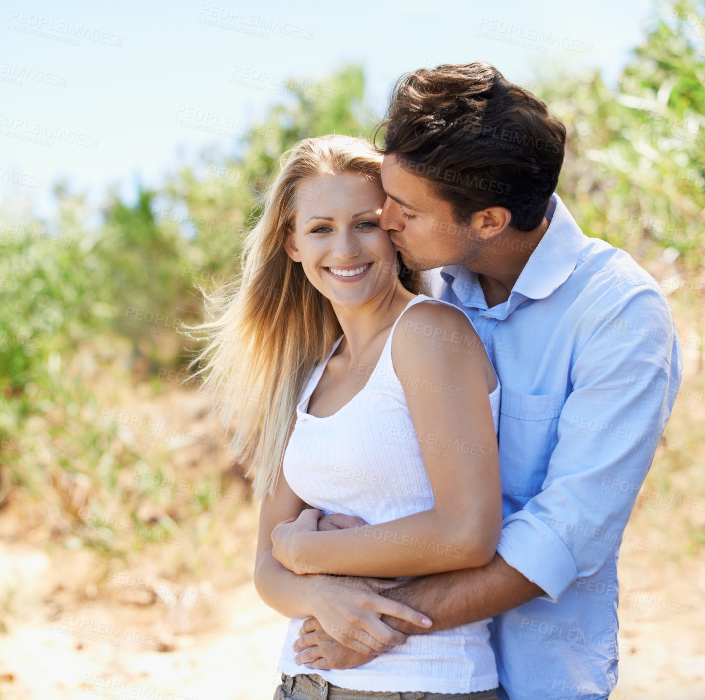 Buy stock photo Couple, portrait and happy in nature with kiss in relationship for holiday, vacation or travel. Romance, man and woman with smile outdoor in forest with embrace for bonding, love or relax in woods