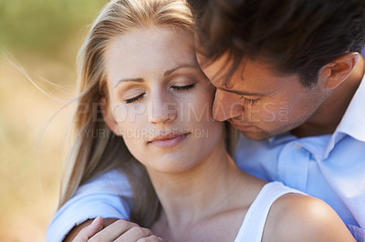 Buy stock photo Couple, hug and embrace in nature for love, bonding or support for outdoor affection or comfort. Face or closeup of relaxed young woman and man in calm, peace or romance in forest or woods together