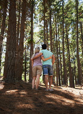 Buy stock photo Couple, hiking and hug in forest for love, embrace or support in trust, care or bonding in nature. Rear view or back of young man and woman in romance, affection or walking together in outdoor woods
