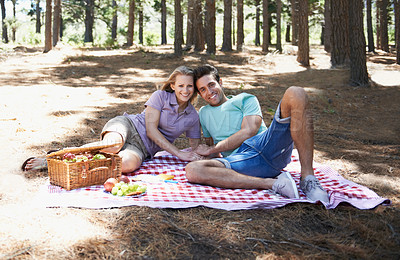Buy stock photo Happy couple, picnic portrait and nature with love, romantic celebration and summer date for valentines day. Young people with food, fruits and relax on blanket in woods or forest for anniversary