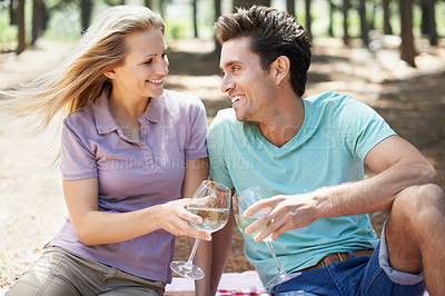 Buy stock photo Happy couple, wine glass and forest or park for cheers of love, holiday and valentines day picnic. Man and woman with champagne, drinks and toast on date and excited for anniversary in nature