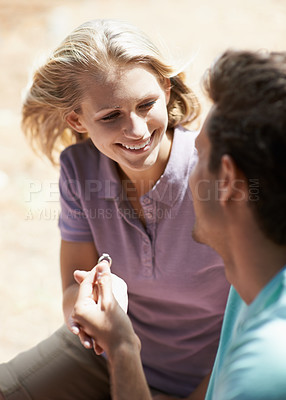 Buy stock photo Happy couple, engagement and ring in nature for marriage, love or commitment in forest or outdoor romance. Young man proposing to woman or lovers smile in embrace or affection for wedding proposal