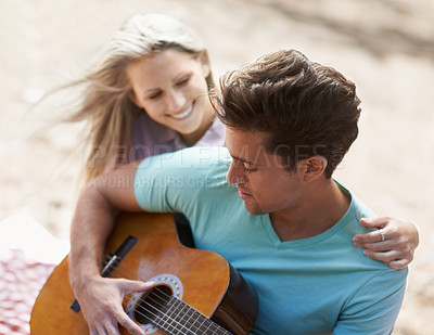 Buy stock photo Couple, picnic and playing guitar for romance, love or song in outdoor bonding, fun or relaxing together in nature. Man and woman smile with instrument for acoustic sound, strumming or music outside