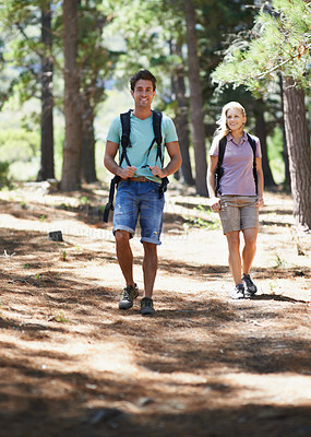 Buy stock photo Couple of friends, travel and hiking in forest for fitness, outdoor adventure and wellness or health in nature. Portrait of happy man and woman walking and trekking with backpack on path and journey