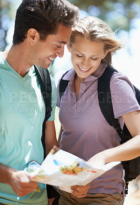 Buy stock photo Couple, hiking in forest and lost with map, documents guide or location information for nature travel or journey. Young woman and man trekking and planning or search paper for direction in the woods