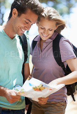 Buy stock photo Couple, hiking in nature and lost with map, documents guide or location information of forest travel or journey. Young woman and man trekking and planning or search paper for direction in the woods