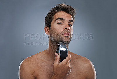 Buy stock photo Man, shaving and electric razor in studio portrait for grooming, skincare and wellness by grey background. Person, model and beard with hygiene, facial hair removal and product for cosmetic change