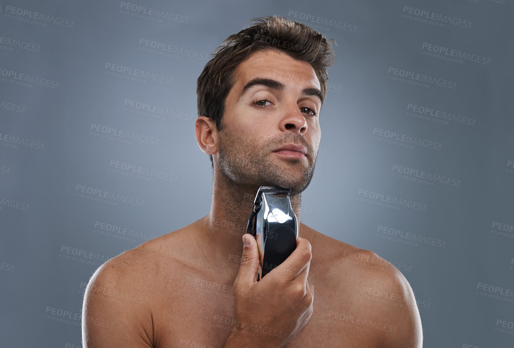 Buy stock photo Man, shaving and electric razor in studio portrait for grooming, skincare and wellness by grey background. Person, model and beard with hygiene, facial hair removal and product for cosmetic change