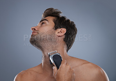Buy stock photo Man, electric shaver and beard in studio for grooming, skincare or wellness for neck by grey background. Person, model and self care for hygiene, facial hair removal or clippers for cosmetic change