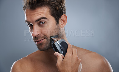 Buy stock photo Man, beard and electric razor in studio portrait for grooming, skincare and wellness by grey background. Person, model and shaving with hygiene, facial hair removal and product for cosmetic change