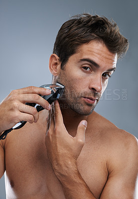 Buy stock photo Man, grooming and electric razor in studio portrait for beard, skincare and wellness by grey background. Person, model and shaving with hygiene, facial hair removal and product for cosmetic change