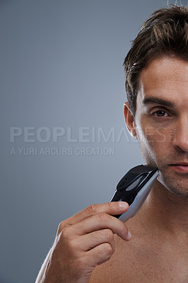 Buy stock photo Man, electric shaver and grooming with closeup studio portrait, space and mockup by grey background. Person, model and shaving beard with hygiene, facial hair removal or product for cosmetic change