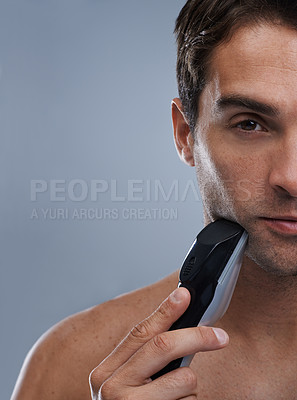 Buy stock photo Man, electric shaver and face with closeup studio portrait, grooming and skincare by grey background. Person, model and shaving beard with hygiene, facial hair removal or mockup for cosmetic change