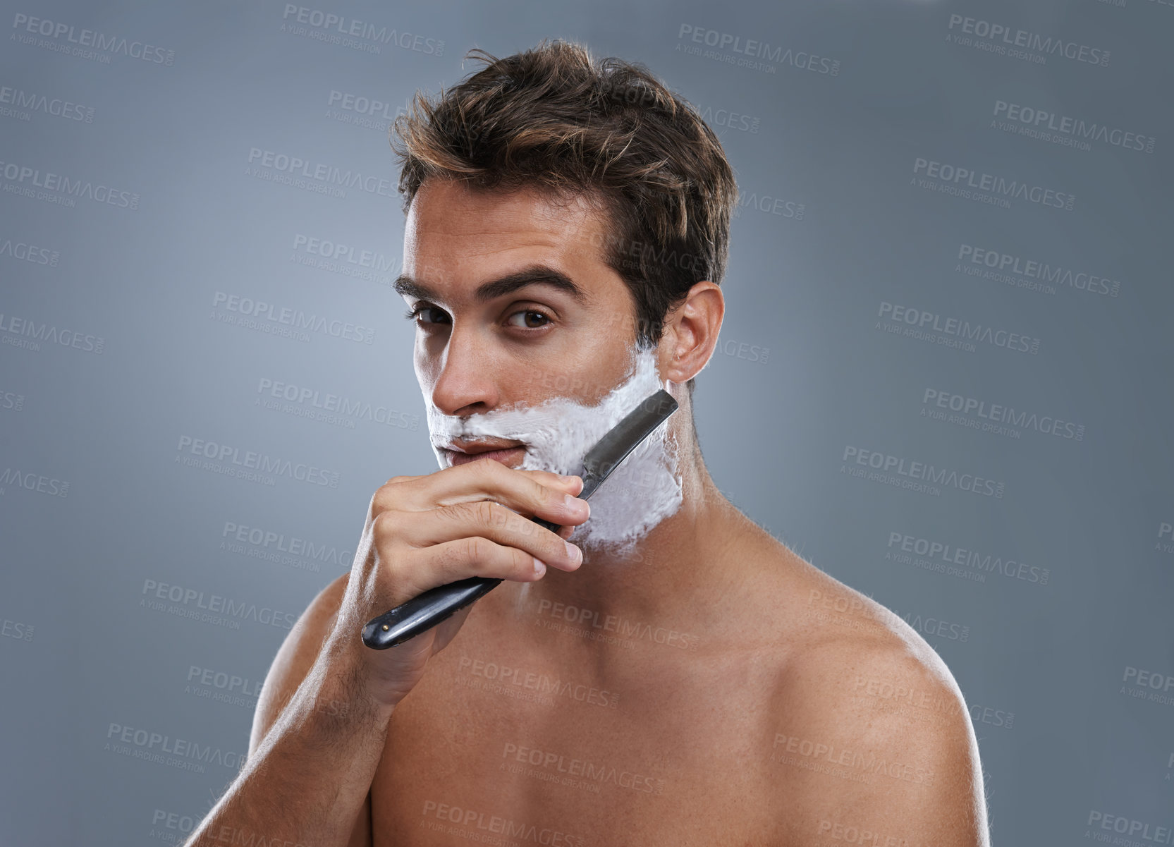 Buy stock photo Man, shaving cream and studio portrait with blade for wellness, skincare and grooming by grey background. Person, model and self care with beard, facial hair removal and product for cosmetic change