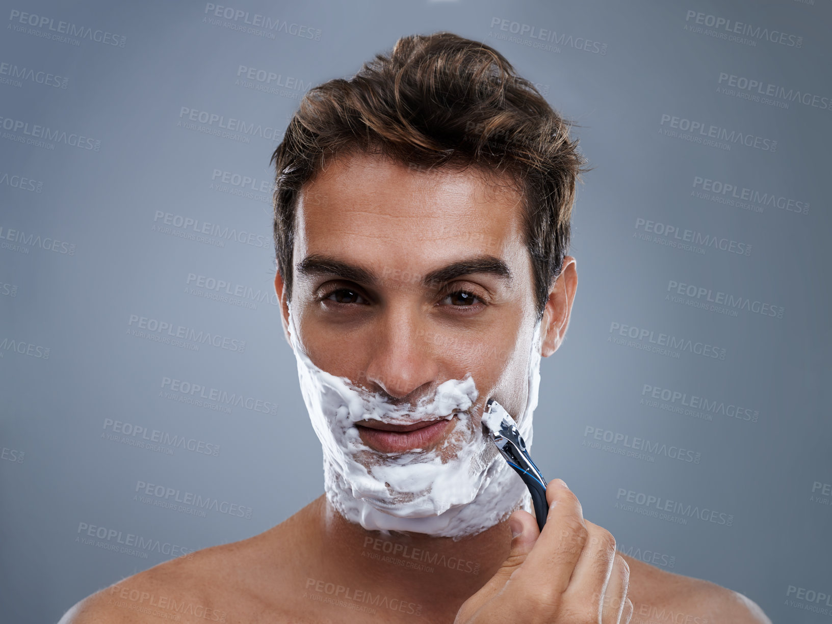 Buy stock photo Man, razor and shaving beard in studio portrait for grooming, skincare and wellness by grey background. Person, model and blade with cream, facial hair removal and foam product for cosmetic change