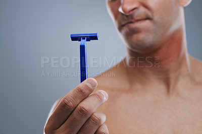 Buy stock photo Grooming, man and razor with routine, closeup and cleaning on a grey studio background. Person, hand and model with tool, cosmetics and treatment with dermatology and equipment with hair removal