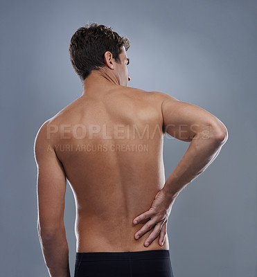 Buy stock photo Injury, crisis and studio man with back pain emergency, sore spine or chiropractic backache. Osteoporosis, orthopedic problem and person with body ache, accident or muscle risk on grey background