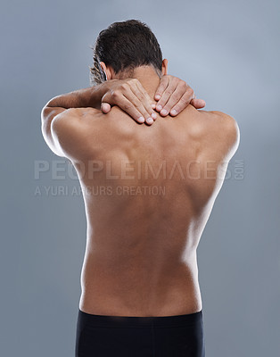 Buy stock photo Back pain, injury problem and studio person with medical emergency, sore backbone or osteoporosis. Backache, spine risk and model with body ache, fibromyalgia or hurt muscle strain on grey background