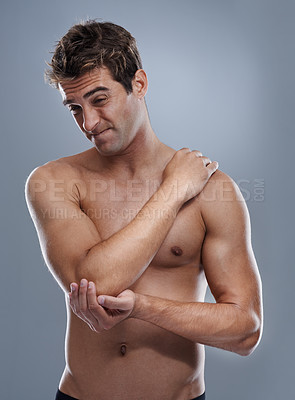 Buy stock photo Arm, pain and man with elbow injury, medical emergency and massage tender osteoarthritis risk. Arthritis, osteoporosis and studio person with bone problem, accident or hurt anatomy on grey background
