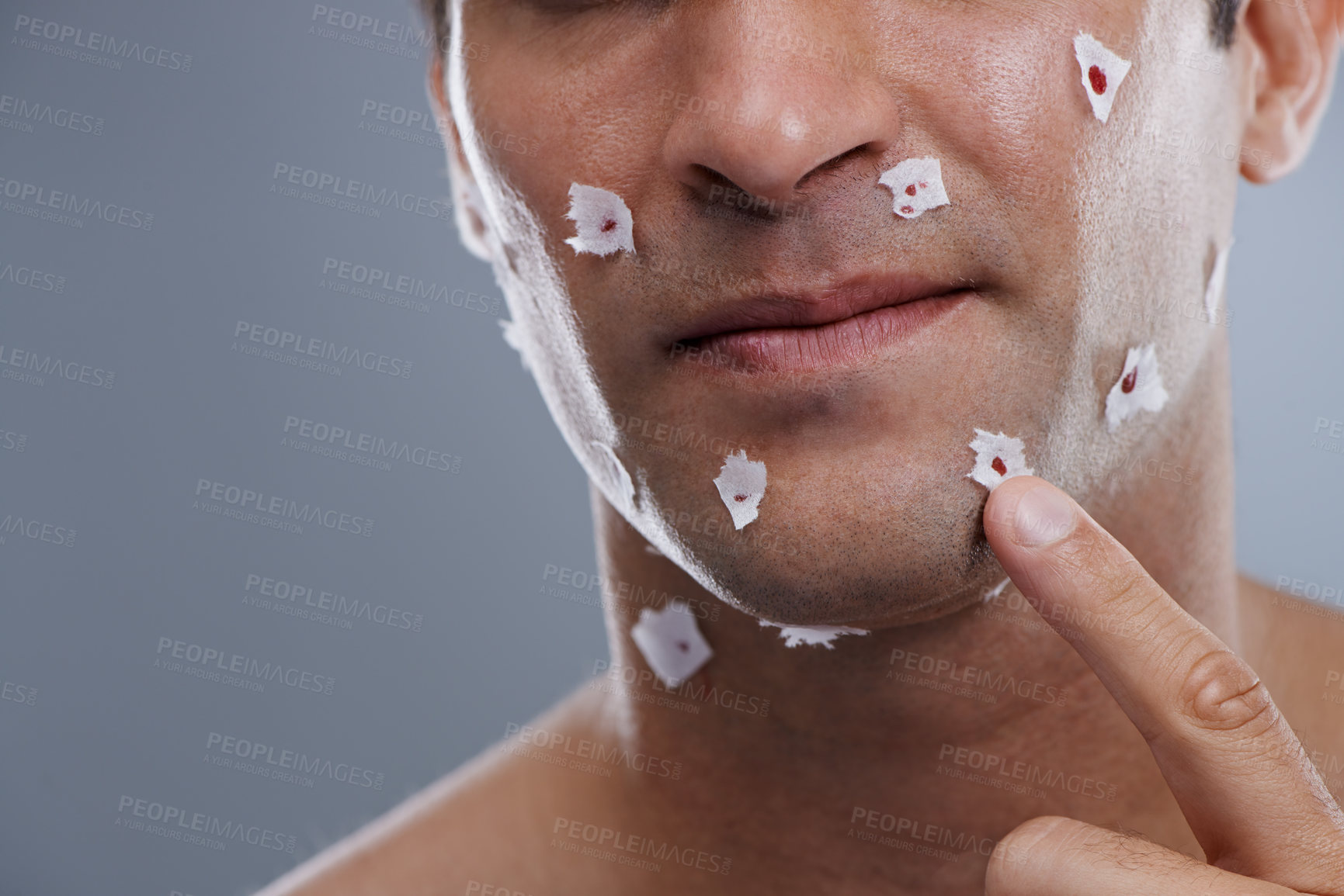 Buy stock photo Man, cuts and skincare with close shave, grooming and morning routine on grey studio background. Person, face and model with paper and bleeding with hair removal and irritation with hygiene or facial