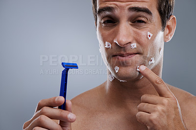 Buy stock photo Man, face and shave cuts or pain for hair removal or hygiene injury with blood, tissue or maintenance. Male person, grey background and dermatology with beard or clean health, studio or mockup space