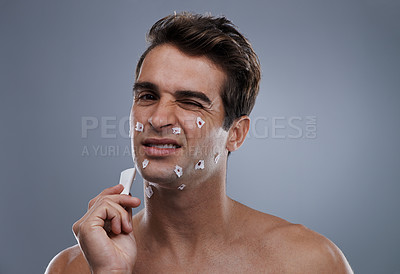 Buy stock photo Man, face and shave cuts or hygiene for hair removal or injury with blood, tissue or maintenance. Male person, grey background and dermatology with beard or clean health, wellness or mockup space