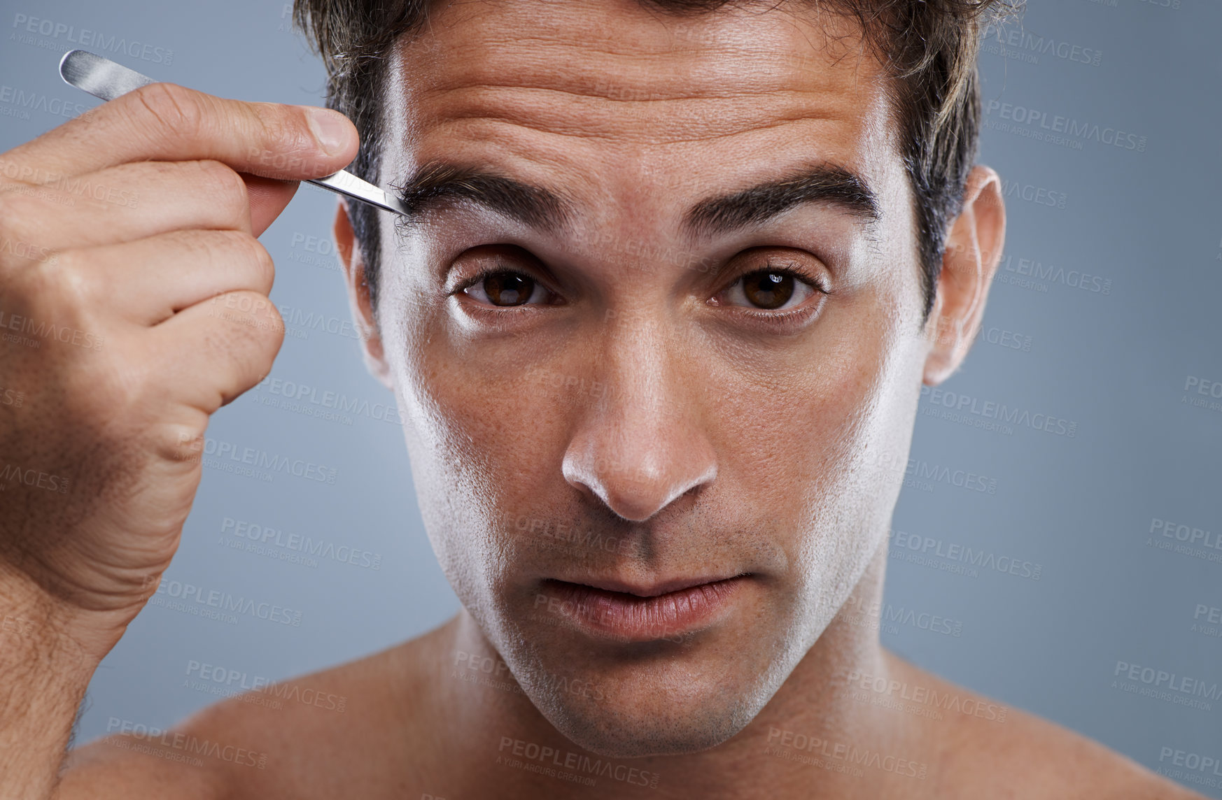 Buy stock photo Man, portrait and tweezers for eyebrows or wellness for face grooming, hygiene or grey background. Male person, tools and hair removal for healthy morning routine or studio, treatment or mockup space