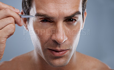 Buy stock photo Man, portrait and tweezers for eyebrows or grooming for face clean, hygiene or grey background. Male person, pluck and hair removal for healthy morning routine or studio, treatment or mockup space